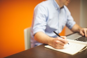 Man at Table with PC Notepad